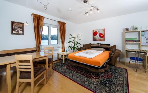 a bedroom with a bed and a table and a dining room at Haus Babin in Techelsberg am Worthersee