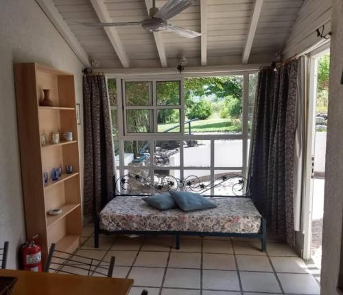 a room with a bed in front of a window at Cabañas ANANDA KANAN in Villa Giardino