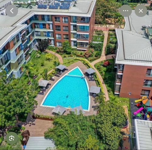 an overhead view of a swimming pool in a building at Pearl Properties three bedroom apartment in Trofwi