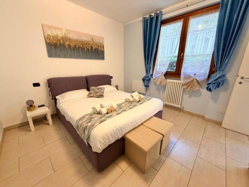 a bedroom with a bed with blue curtains at Belvedere in Costa - Lake View in Bellano