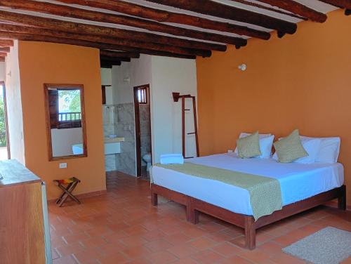 a bedroom with two beds in a room at HotelQuintaMaria in Barichara