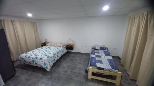 a bedroom with a twin bed and a bedskirts at Alojamiento Hugo in Río Segundo