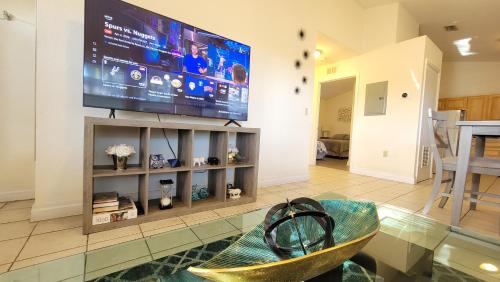 a living room with a large flat screen tv at Stylish House Near UF, VA, & Downtown Gainesville in Gainesville