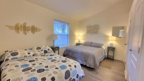 a bedroom with two beds and a window at Stylish House Near UF, VA, & Downtown Gainesville in Gainesville