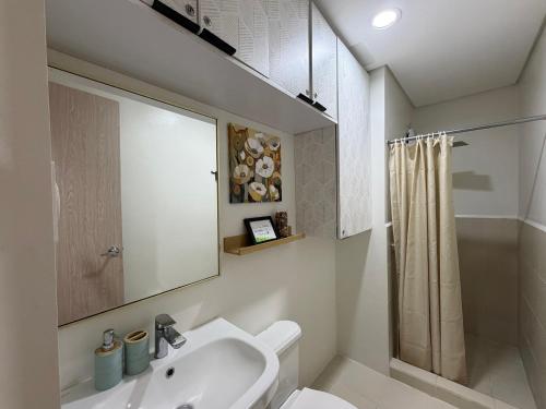 a bathroom with a sink and a toilet and a shower at 2BR Unit at Hill Residences I Free Parking in Manila