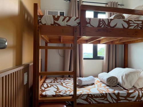 a bedroom with two bunk beds and a bed at 2BR Unit at Hill Residences I Free Parking in Manila