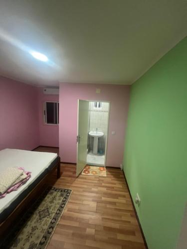 a bedroom with a bed and a door to a bathroom at Holiday Home T3 to T6 on suite in Amparo II