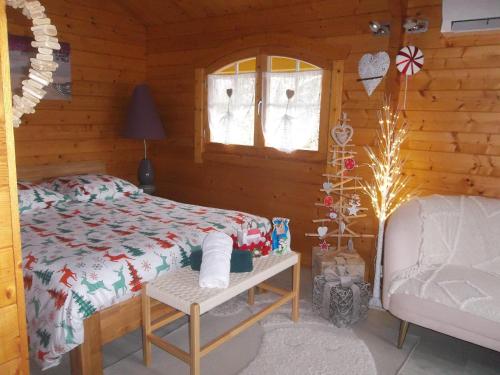 a bedroom with a bed in a log cabin at Chalet flottant sur lac et spa in Mios