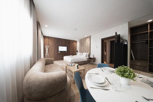 a hotel room with a bed and a table and chairs at Suites Nador in Nador
