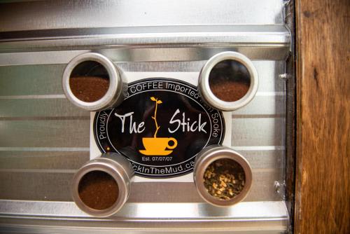 a sign for a coffee maker with three cups of coffee at Stay and Spa in Sooke
