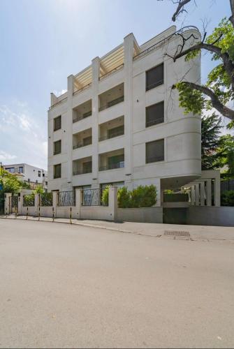 a white building on the side of a street at Dedinje Luxury Apartment with Spa & Garage in Belgrade