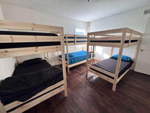 a room with three bunk beds in a room at La Cienega Near The Grove & Public Transit in Los Angeles