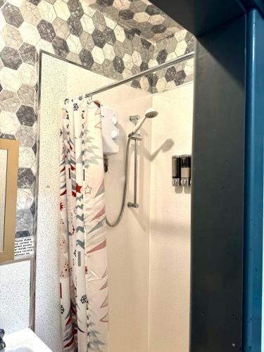 a bathroom with a shower with a shower curtain at blackpool central lodge And Rooms in Blackpool