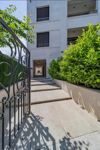 a gate in front of a building with plants at Dedinje Luxury Apartment with Spa & Garage in Belgrade