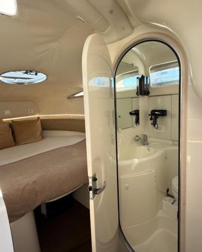 a small bathroom with a tub and a sink at HouseBoat on the river-DouroHeritage in Porto