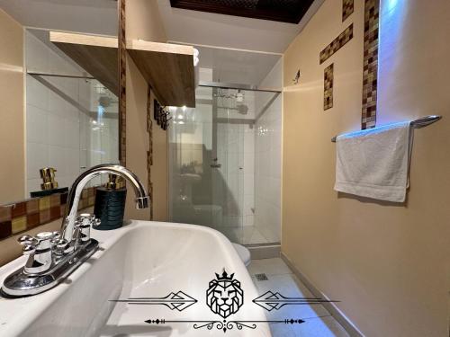 a bathroom with a sink and a shower at Casa Hotel Imperion in Bogotá