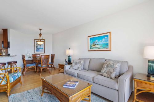 a living room with a couch and a table at Penthouse Oceanview Vistas in Kihei