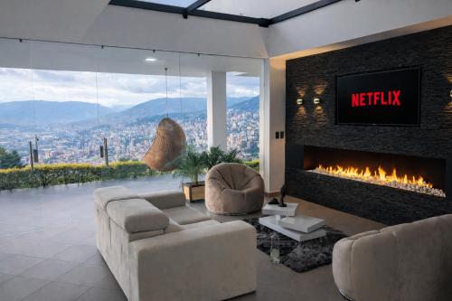a living room with a couch and a fireplace at Glass Mansion Breathtaking 180 Panoramic View in Envigado