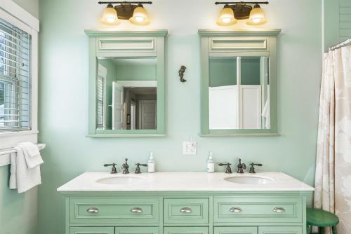 a bathroom with two sinks and two mirrors at Acadia View Cottage Peaceful, Pet Friendly, Fire Pit, Near Peaks and Echo Lake in Hall Quarry