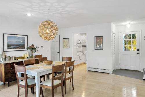 a kitchen and dining room with a table and chairs at Northern Nest MDI Lakefront Single-Level, Dual King Bedrooms & Private Dock in Pretty Marsh