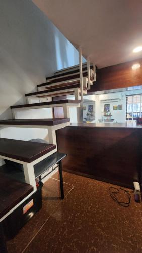 a kitchen with a table and a counter top at Casa Minsorado in General Trias