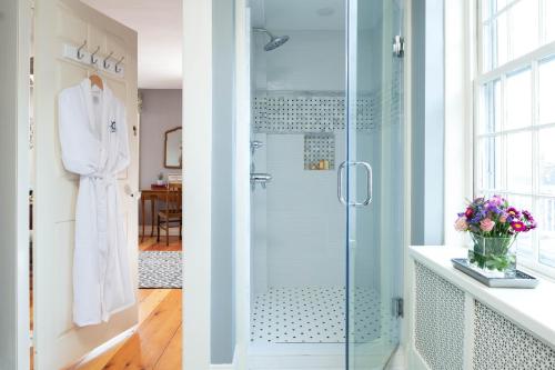 two images of a bathroom with a shower at Captain Swift Inn in Camden