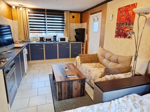 a living room with a couch and a table at Ruhe Oase mit Gartenblick in Büren