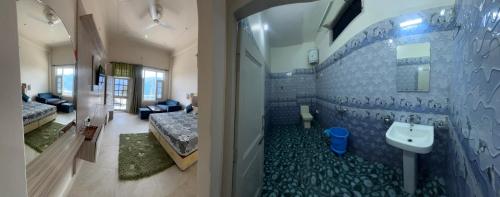 a bathroom with a toilet and a sink in it at Himalayan Canvas khajjiar in Khajjiar 