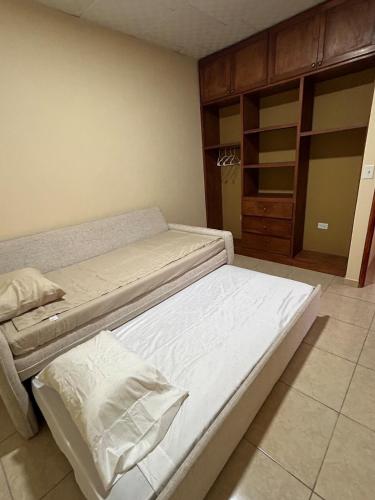 a bedroom with two beds and a closet at Oasis House 2 in Tocumen