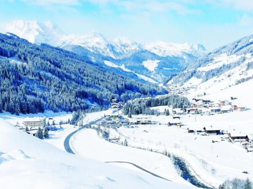 a snow covered valley with a village in the mountains at Haus Sonnleiten in Gerlos