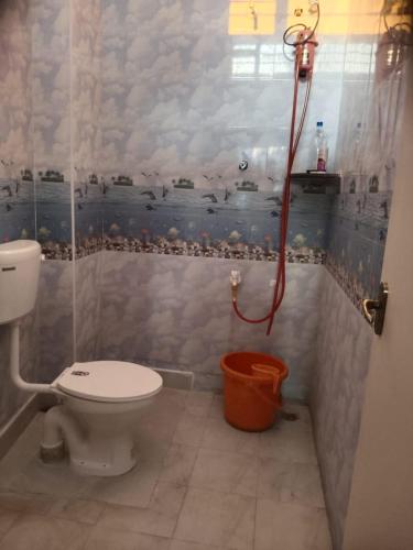 a bathroom with a toilet and a shower at JPR Cottage in Erode