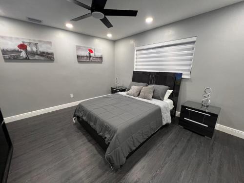 a bedroom with a bed and a ceiling fan at Fun n Chic house with pool in Miami in Golden Glades