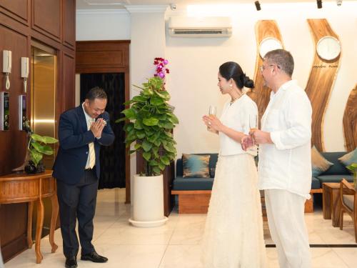 a bride and groom standing in a hotel lobby at Le Kree Downtown Hotel in Phnom Penh
