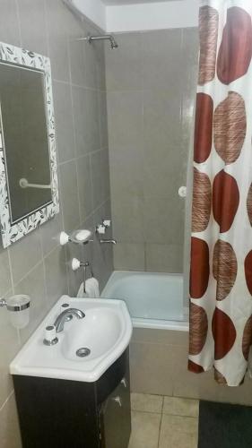 a bathroom with a sink and a bath tub at Mdp in Mar del Plata