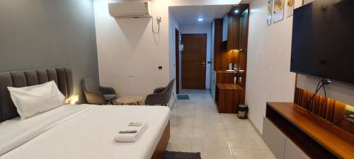 a hotel room with a bed and a bathroom at RrHEAVENSTAY in Nalmatha