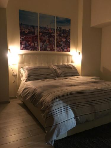a bedroom with a large white bed with two lamps at Morra's Home in Naples