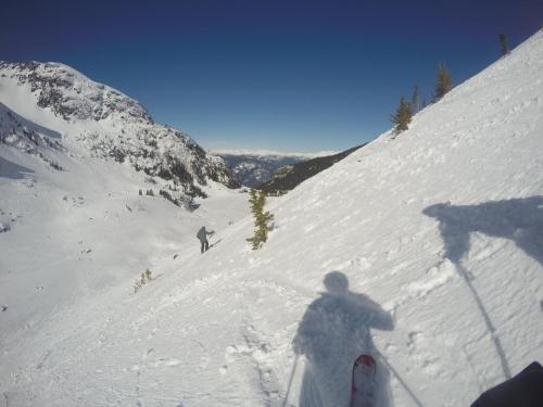 two people are skiing down a snow covered mountain at RUBY LODGINg in Banilad