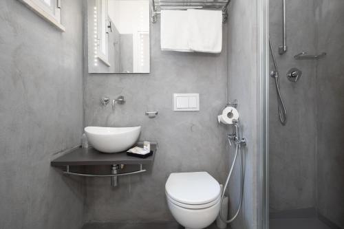 a bathroom with a toilet and a sink and a shower at BI Hotel in Bellaria-Igea Marina