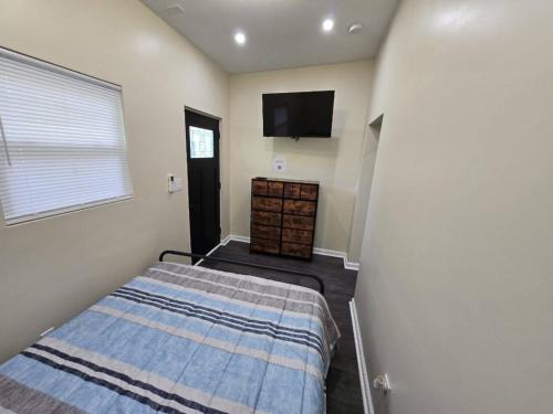 a bedroom with a bed and a flat screen tv at G O G Building in Darby