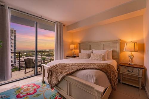 a bedroom with a bed and a large window at Modern Studio Pool View Downtown Doral' Heart in Miami