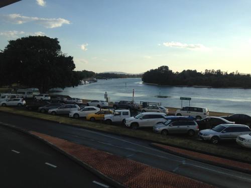 a bunch of cars parked next to a river at Lakes and Ocean Hotel Forster in Forster