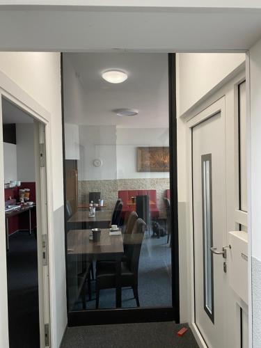 an office with a table and chairs and a room at Pension Zum Angestellten in Porta Westfalica