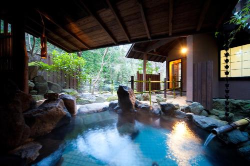a swimming pool in the middle of a house at Sanso Tensui in Hita