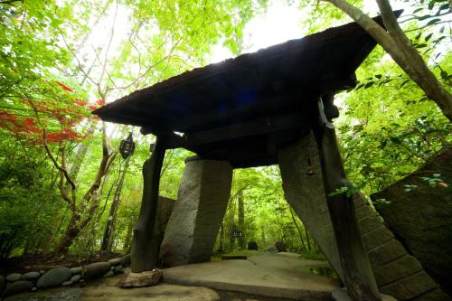 a small building in the middle of a forest at Sanso Tensui in Hita