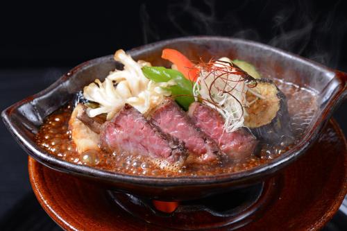 a bowl of food with meat and vegetables on a table at Sanso Tensui in Hita