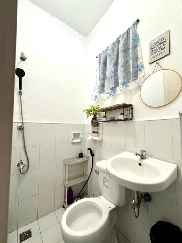 a bathroom with a toilet and a sink at LoveCo Vacation house close to Dahilayan with private parking in Manolo Fortich