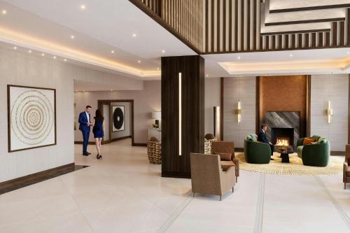 a lobby of a hotel with people sitting in chairs at London Marriott Hotel Marble Arch in London