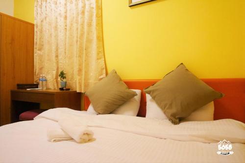 a bedroom with a bed with a teddy bear on it at Dabing home in Tainan in Tainan