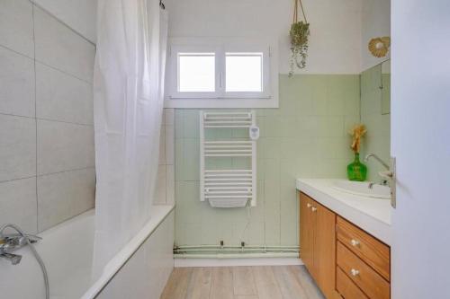 a bathroom with a tub and a sink and a shower at Maison de charme à st émilion in Saint-Émilion