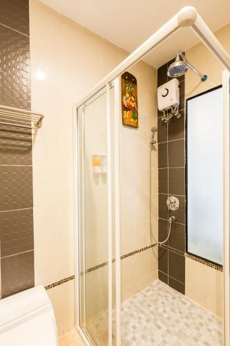 a shower with a glass door in a bathroom at Lee Chiang Hotel in Chiang Mai